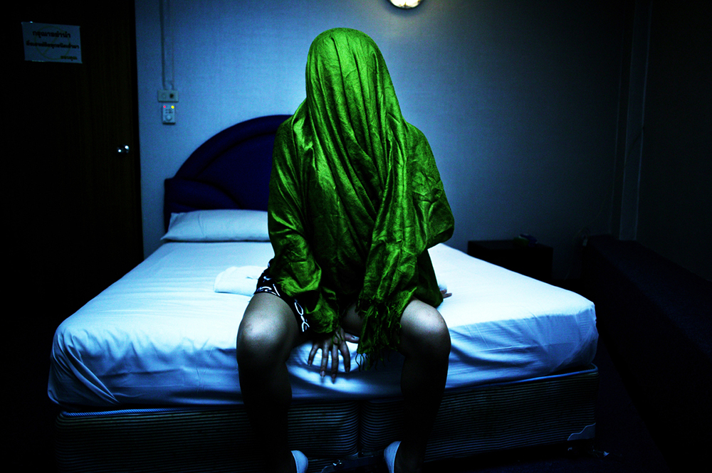 Bangkok, February 24, 2008 : Anne, a young sex worker sits on a bed in a short-time hotel . Anne has a foreign boyfriend who sends her a monthly allowance , but doesn't know that she's still working in the sex trade. Anne says though that the redlight districts are a good opportunity to meet other girls from rural Thailand who -like herself- came to Bangkok.