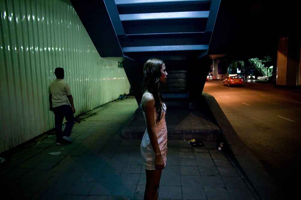Bangkok, June 21, 2008 : a sex worker stands in a street in Bangkok waiting for customers.