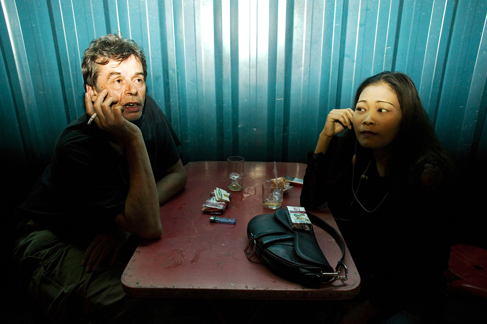 Bangkok, 2007-2011 :.synopsis : Human Negotiations is an independent, self-funded collaboration between photographer Katharina Hesse and writer Lara Day, exploring the lives of a community of Bangkok sex workers through both images and text..The project came into being in 2007, when Hesse and Day met during a photography workshop. Over the course of three years, the pair returned to Bangkok's red-light districts repeatedly to interview and photograph more than two dozen women..Human Negotiations is not a journalistic account of the sex trade, but instead a personal interpretation of a line of work that is frequently misunderstood. Leaving aside stereotypes of exploited, downtrodden Third World females coerced into a profession in which they are passive victims, the project reveals a more nuanced, open-ended world where women take center stage, and where reality's complexities leave room for wider interpretations..Documentary photographs and fictional vignettes based on personal interviews focus on subjects who have not been coerced into their jobs, but who choose to work in the sex industry as a means towards a better life: a mother supporting a child, a ladyboy saving up for cosmetic surgery, a girl from the countryside looking to strike it rich in the big city, a woman living the lifestyle to enable her own freedom and independence..... ."What Hesse and Day present in Human Negotiations, is a unique and highly personal look at a facet of the sex industry rarely documented before, challenging the perception of women and sex. It is both emotionally powerful and poignant, with its visual rhythm reflecting the lives the women live and the city which forms the backdrop to this story. But it does not seek to answer all the questions raised, instead Hesse and Day present a stepping off point from which a larger dialogue may begin. " ( Wayne Ford)