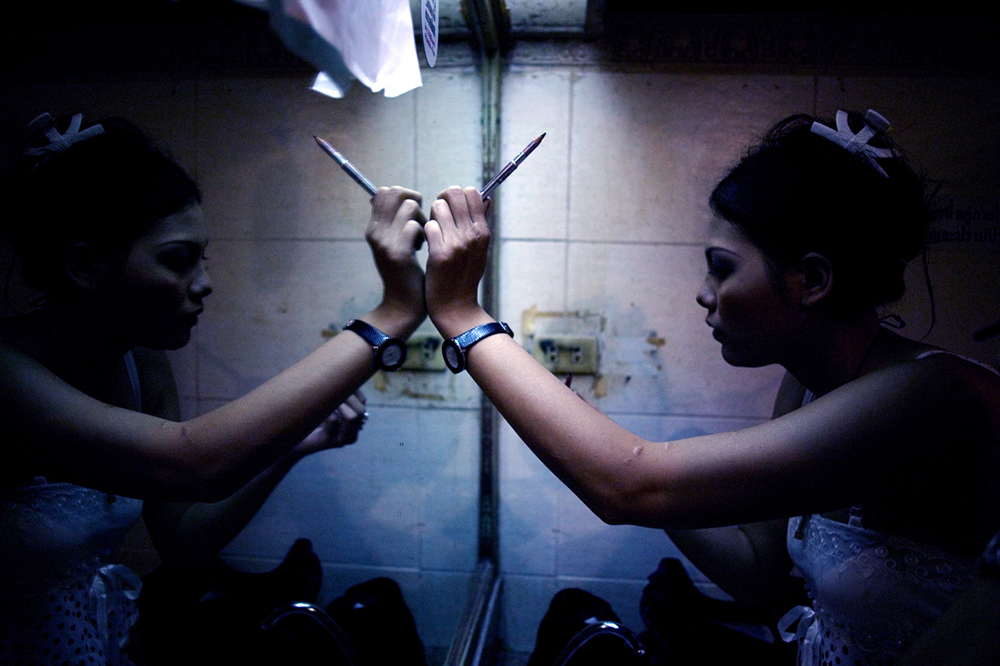 Bangkok, 2007-2011 :.synopsis : Human Negotiations is an independent, self-funded collaboration between photographer Katharina Hesse and writer Lara Day, exploring the lives of a community of Bangkok sex workers through both images and text..The project came into being in 2007, when Hesse and Day met during a photography workshop. Over the course of three years, the pair returned to Bangkok's red-light districts repeatedly to interview and photograph more than two dozen women..Human Negotiations is not a journalistic account of the sex trade, but instead a personal interpretation of a line of work that is frequently misunderstood. Leaving aside stereotypes of exploited, downtrodden Third World females coerced into a profession in which they are passive victims, the project reveals a more nuanced, open-ended world where women take center stage, and where reality's complexities leave room for wider interpretations..Documentary photographs and fictional vignettes based on personal interviews focus on subjects who have not been coerced into their jobs, but who choose to work in the sex industry as a means towards a better life: a mother supporting a child, a ladyboy saving up for cosmetic surgery, a girl from the countryside looking to strike it rich in the big city, a woman living the lifestyle to enable her own freedom and independence..... ."What Hesse and Day present in Human Negotiations, is a unique and highly personal look at a facet of the sex industry rarely documented before, challenging the perception of women and sex. It is both emotionally powerful and poignant, with its visual rhythm reflecting the lives the women live and the city which forms the backdrop to this story. But it does not seek to answer all the questions raised, instead Hesse and Day present a stepping off point from which a larger dialogue may begin. " ( Wayne Ford)