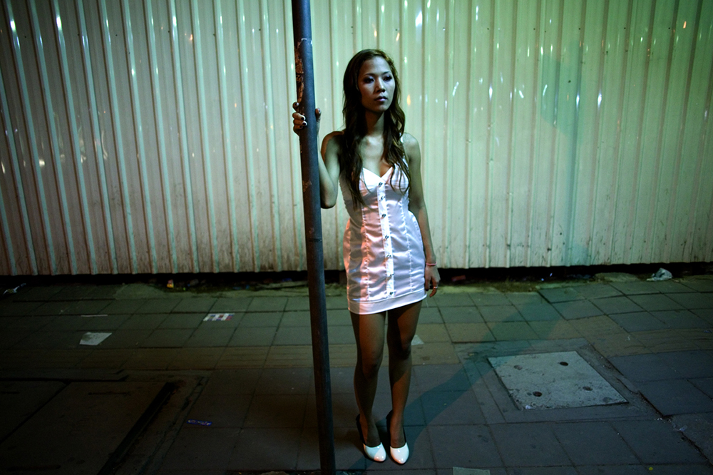 Bangkok, 2007-2011 :.synopsis : Human Negotiations is an independent, self-funded collaboration between photographer Katharina Hesse and writer Lara Day, exploring the lives of a community of Bangkok sex workers through both images and text..The project came into being in 2007, when Hesse and Day met during a photography workshop. Over the course of three years, the pair returned to Bangkok's red-light districts repeatedly to interview and photograph more than two dozen women..Human Negotiations is not a journalistic account of the sex trade, but instead a personal interpretation of a line of work that is frequently misunderstood. Leaving aside stereotypes of exploited, downtrodden Third World females coerced into a profession in which they are passive victims, the project reveals a more nuanced, open-ended world where women take center stage, and where reality's complexities leave room for wider interpretations..Documentary photographs and fictional vignettes based on personal interviews focus on subjects who have not been coerced into their jobs, but who choose to work in the sex industry as a means towards a better life: a mother supporting a child, a ladyboy saving up for cosmetic surgery, a girl from the countryside looking to strike it rich in the big city, a woman living the lifestyle to enable her own freedom and independence..... ."What Hesse and Day present in Human Negotiations, is a unique and highly personal look at a facet of the sex industry rarely documented before, challenging the perception of women and sex. It is both emotionally powerful and poignant, with its visual rhythm reflecting the lives the women live and the city which forms the backdrop to this story. But it does not seek to answer all the questions raised, instead Hesse and Day present a stepping off point from which a larger dialogue may begin. " ( Wayne Ford)