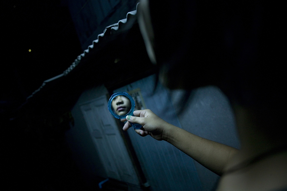 Bangkok, 2007-2011 :.synopsis : Human Negotiations is an independent, self-funded collaboration between photographer Katharina Hesse and writer Lara Day, exploring the lives of a community of Bangkok sex workers through both images and text..The project came into being in 2007, when Hesse and Day met during a photography workshop. Over the course of three years, the pair returned to Bangkok's red-light districts repeatedly to interview and photograph more than two dozen women..Human Negotiations is not a journalistic account of the sex trade, but instead a personal interpretation of a line of work that is frequently misunderstood. Leaving aside stereotypes of exploited, downtrodden Third World females coerced into a profession in which they are passive victims, the project reveals a more nuanced, open-ended world where women take center stage, and where reality's complexities leave room for wider interpretations..Documentary photographs and fictional vignettes based on personal interviews focus on subjects who have not been coerced into their jobs, but who choose to work in the sex industry as a means towards a better life: a mother supporting a child, a ladyboy saving up for cosmetic surgery, a girl from the countryside looking to strike it rich in the big city, a woman living the lifestyle to enable her own freedom and independence..... ."What Hesse and Day present in Human Negotiations, is a unique and highly personal look at a facet of the sex industry rarely documented before, challenging the perception of women and sex. It is both emotionally powerful and poignant, with its visual rhythm reflecting the lives the women live and the city which forms the backdrop to this story. But it does not seek to answer all the questions raised, instead Hesse and Day present a stepping off point from which a larger dialogue may begin. " ( Wayne Ford)